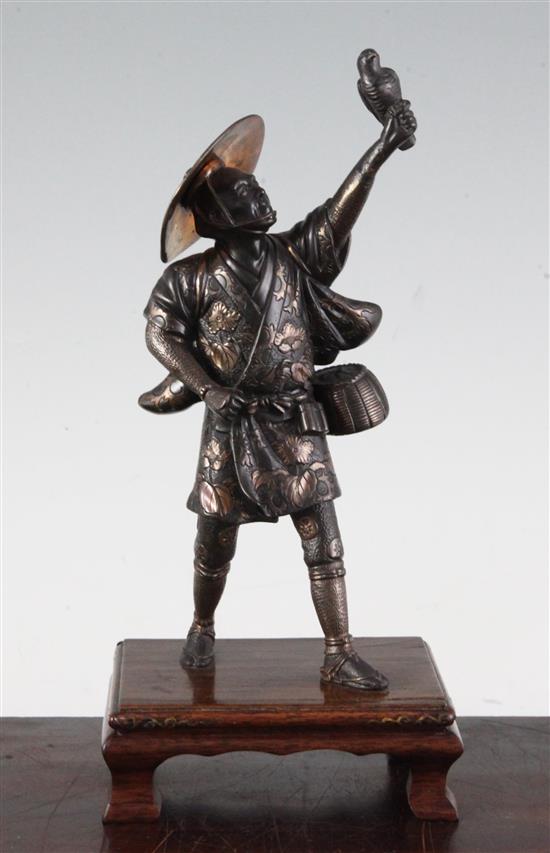 A Japanese two-colour bronze figure of a falconer, by Miyao, Meiji period, total height 26cm, lacking item to left hand